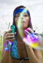 Woman blowing soap bubble