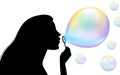 Woman blowing soap bubbles, portrait silhouette. Elegant profile portrait of a young beautiful woman