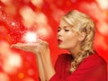 woman blowing something on the palms of her hands Royalty Free Stock Photo