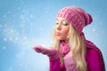 Woman blowing to snowflakes