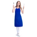 Woman in blue apron smile holding fork and knife in hands Royalty Free Stock Photo