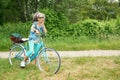 Woman with blue bike smiling Outdoor nature green vegetation Royalty Free Stock Photo