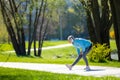 Woman in blue blazer doing leanings in the park Royalty Free Stock Photo