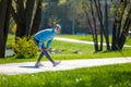 Woman in blue blazer doing leanings in the park