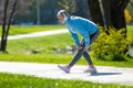 Woman in blue blazer doing leanings in the park Royalty Free Stock Photo