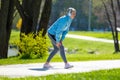 Woman in blue blazer doing leanings in the park Royalty Free Stock Photo