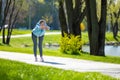 Woman in blue blazer doing leanings in the park