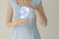 Woman in blue clothes holding virtual spleen in hand. Handrawn human organ, detox and healthcare, healthcare hospital service