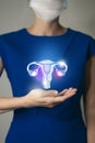 Unrecognizable woman in blue clothes holding highlighted handrawn Uterus in hands. Medical illustration, template, science mockup