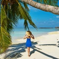 Woman in blue dress on a beach at Maldives Royalty Free Stock Photo