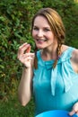 Woman in blue dress eating blackberries Royalty Free Stock Photo