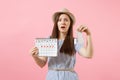 Woman in blue dress, hat holding sanitary napkin, tampon female periods calendar, checking menstruation days isolated on