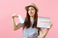 Woman in blue dress, hat holding sanitary napkin, tampon female periods calendar, checking menstruation days isolated on Royalty Free Stock Photo