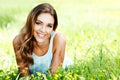 Woman in blue dress lying on grass