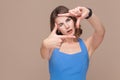 Woman in blue dress showing perspective frame or crop