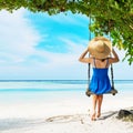 Woman in blue dress swinging at beach Royalty Free Stock Photo