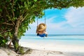 Woman in blue dress swinging at beach Royalty Free Stock Photo