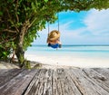 Woman in blue dress swinging at beach Royalty Free Stock Photo