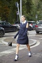 Woman with blue dress and white shirt walking before Sportmax fashion show, Milan Fashion Week