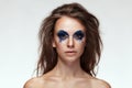 Woman with blue fantasy make up on eyes