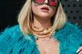 Woman with blue fur coat and golden gecko necklace before Gucci fashion show, Milan Fashion Royalty Free Stock Photo