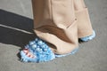 Woman with blue fur slippers and beige trousers before Genny fashion show, Milan Fashion Week