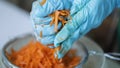 Woman wring out Grated carrots for cooking