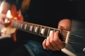 woman in blue hot pants plays chord on electric solidbody guitar with cherry sunburst body. Royalty Free Stock Photo