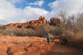 Woman in blue jacket photographing Cathedral Rock in Red Rock State Park outside of Sedona, Arizona in winter. Royalty Free Stock Photo