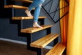 Woman in blue jeans go down in stairs.