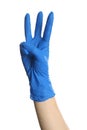 Woman in blue latex gloves showing three fingers on white background, closeup of hand Royalty Free Stock Photo