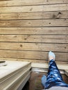 Woman in blue leggings and blue ankle socks stepping out of a door onto a wood porch Royalty Free Stock Photo