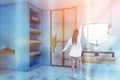Woman in blue and marble bathroom Royalty Free Stock Photo