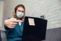 Woman in blue medical mask points her finger at the quarantine message: stay home. Concept of self-isolation and protection,