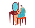 Woman in blue pajamas with stars applying makeup at vanity table. Female in nightwear getting ready morning routine