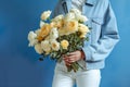 woman blue sweater yellow romantic bouquet giving white floral hand flower. Generative AI. Royalty Free Stock Photo