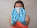 Woman with blue rubber glove make stop gesture Royalty Free Stock Photo