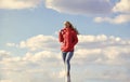 Woman on blue sky background. woman in model pose outdoors. feel free. woman enjoying weather outdoors. Freedom and