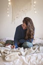 Woman on bed writing in her journal Royalty Free Stock Photo