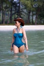 Woman in blue swimsuit walk relax on water Royalty Free Stock Photo