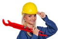 Woman in blue work clothes with pipe wrench