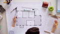 Woman with blueprint, ruler and dividers at office