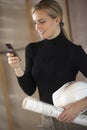 Woman With Blueprints, Hardhat, and Cell Phone Royalty Free Stock Photo