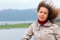 Woman is on board ship and looks into distance