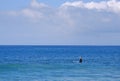 Woman board surfer waiting for a wave in Laguna Beach, California.