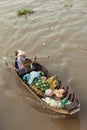 Woman on boat floating down Mekong river , Vietnam Royalty Free Stock Photo
