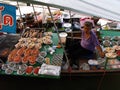 A woman in a boat full of seafood at Amphawa Floating Market Royalty Free Stock Photo