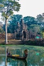 Woman boat moat south gate bridge Angkor Thom Cambodia