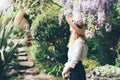 A woman in a boater hat view from the back