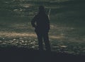 Woman body outline in strong light from frozen lake